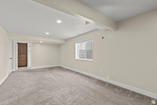 spare room with beam ceiling, recessed lighting, baseboards, and carpet floors