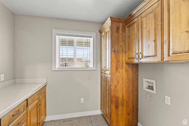 laundry area featuring visible vents, cabinet space, hookup for a washing machine, and baseboards