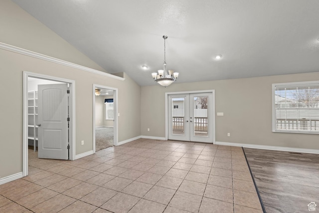 unfurnished room with light tile patterned floors, baseboards, an inviting chandelier, vaulted ceiling, and french doors