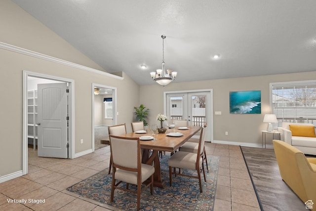 dining space featuring light tile patterned floors, french doors, a notable chandelier, and vaulted ceiling