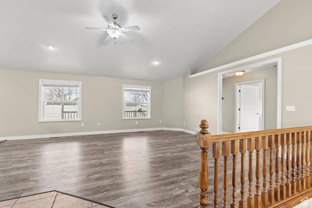 spare room featuring ceiling fan, baseboards, lofted ceiling, and wood finished floors
