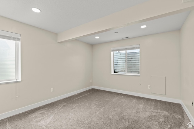 carpeted empty room with beamed ceiling, visible vents, recessed lighting, and baseboards