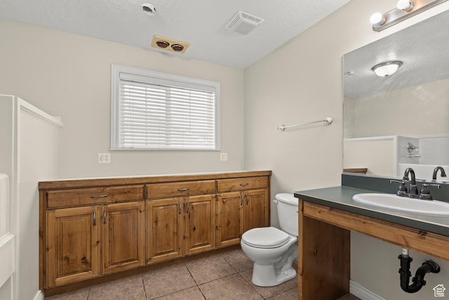 bathroom with tile patterned floors, visible vents, a textured ceiling, and toilet