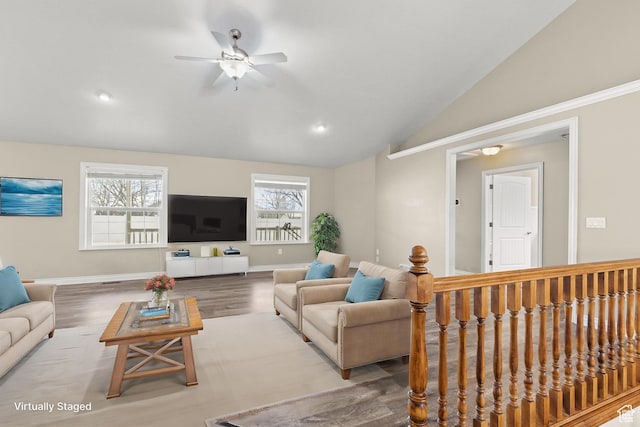 living room featuring baseboards, wood finished floors, ceiling fan, and vaulted ceiling