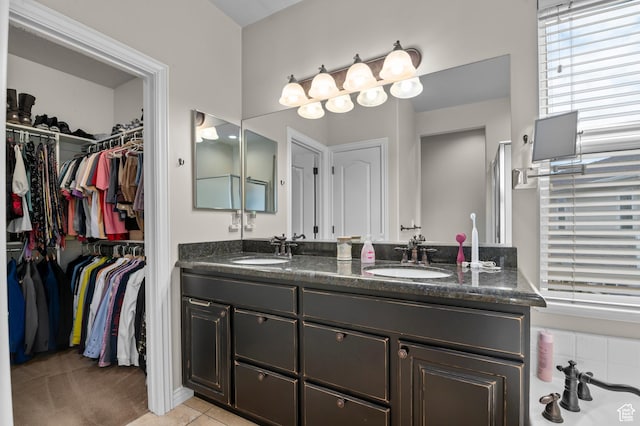 11709 S Grandville Ave, South Jordan, UT 84009 - bathroom with double vanity, a spacious closet, and tile patterned flooring