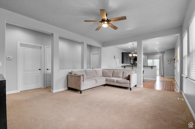 11709 S Grandville Ave, South Jordan, UT 84009 - living room featuring carpet floors, ceiling fan, a chandelier, and recessed lighting