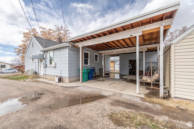 2348 Iowa Ave, Ogden, UT 84401 - back of house featuring a carport and a chimney