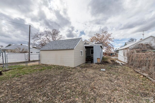 2348 Iowa Ave, Ogden, UT 84401 - rear view of house with an outbuilding, a shingled roof, fence, and a gate