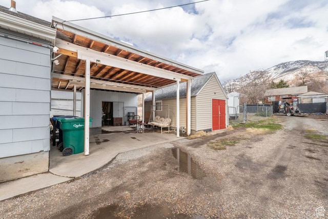 2348 Iowa Ave, Ogden, UT 84401 - view of car parking with a mountain view, driveway, and fence