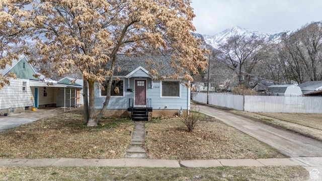 2348 Iowa Ave, Ogden, UT 84401 - bungalow-style home with a carport, a mountain view, concrete driveway, and fence