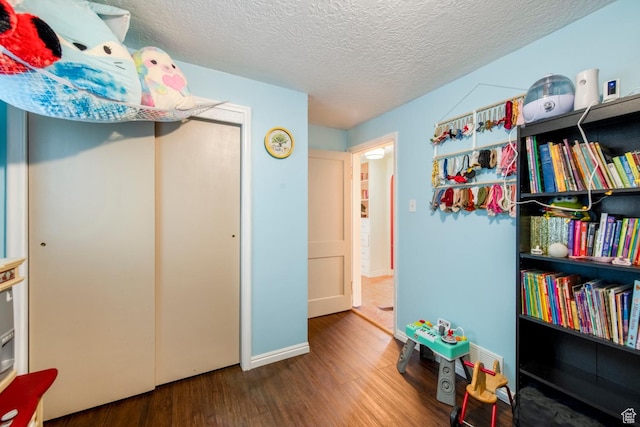 2348 Iowa Ave, Ogden, UT 84401 - playroom with a textured ceiling, baseboards, and wood finished floors