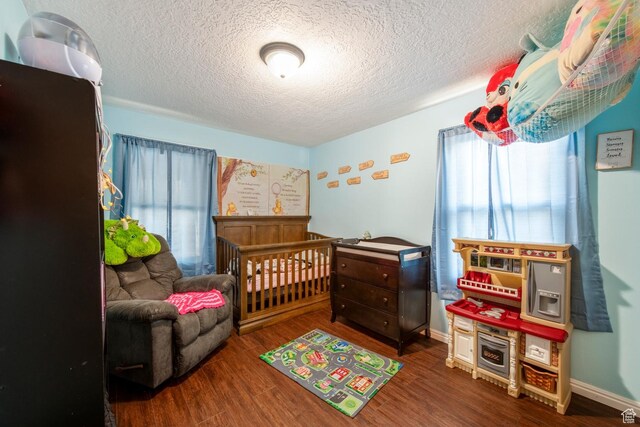 2348 Iowa Ave, Ogden, UT 84401 - bedroom featuring wood finished floors, baseboards, and a textured ceiling