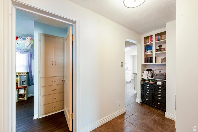 2348 Iowa Ave, Ogden, UT 84401 - hallway featuring baseboards, arched walkways, and a textured ceiling