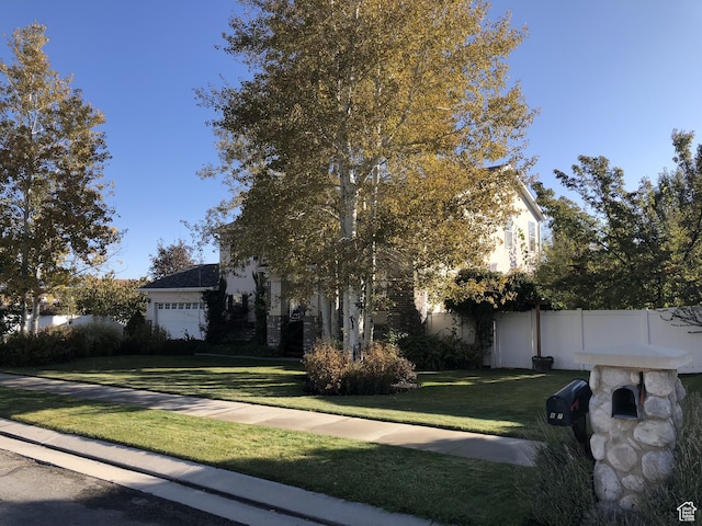 8377 S Wild Oak Dr, West Jordan, UT 84088 - view of front of property with an attached garage, a front lawn, and fence
