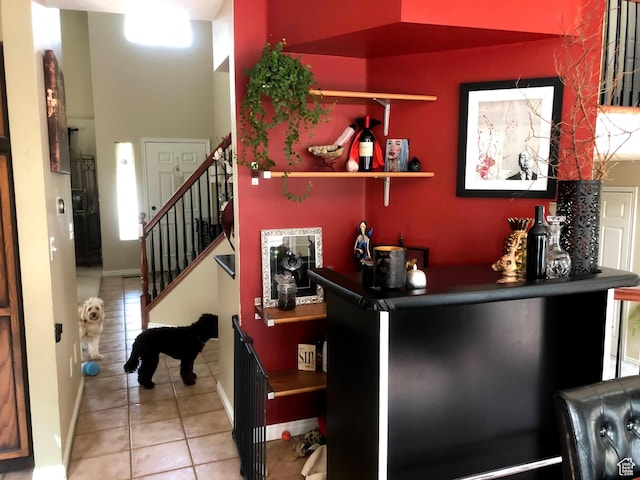 8377 S Wild Oak Dr, West Jordan, UT 84088 - bar featuring tile patterned flooring, stairs, and baseboards