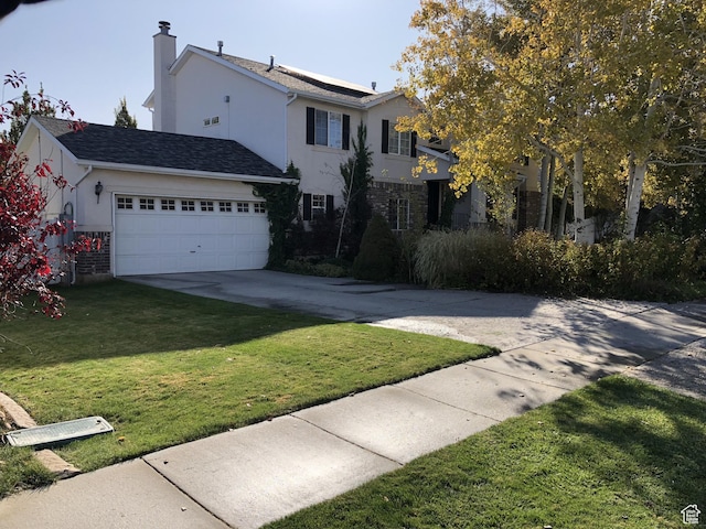 8377 S Wild Oak Dr, West Jordan, UT 84088 - view of front of home featuring stucco siding, an attached garage, concrete driveway, and a front yard