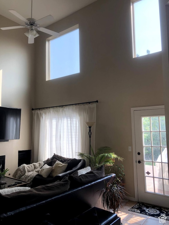 8377 S Wild Oak Dr, West Jordan, UT 84088 - living area featuring a ceiling fan, a high ceiling, and a healthy amount of sunlight