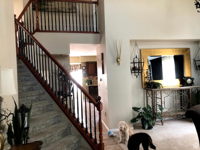 8377 S Wild Oak Dr, West Jordan, UT 84088 - staircase featuring a high ceiling and baseboards