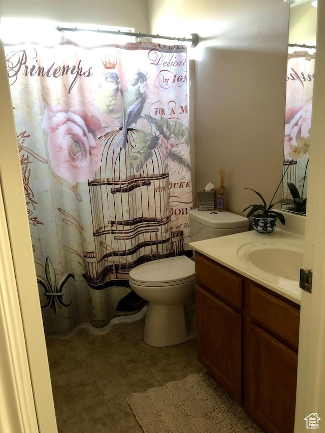 8377 S Wild Oak Dr, West Jordan, UT 84088 - full bathroom with vanity, toilet, and tile patterned flooring