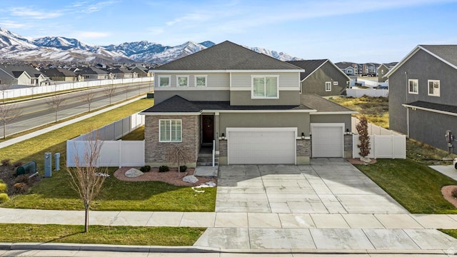 415 W 1410 N Unit 81, Tooele, UT 84074 - view of front of house featuring stucco siding, stone siding, concrete driveway, and fence
