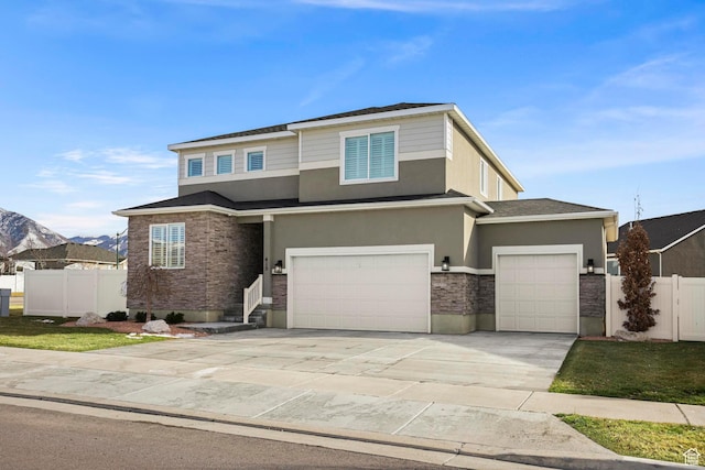 415 W 1410 N Unit 81, Tooele, UT 84074 - view of front of home with stone siding, stucco siding, concrete driveway, and fence