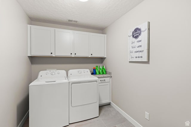 415 W 1410 N Unit 81, Tooele, UT 84074 - washroom featuring visible vents, baseboards, washer and clothes dryer, cabinet space, and a textured ceiling