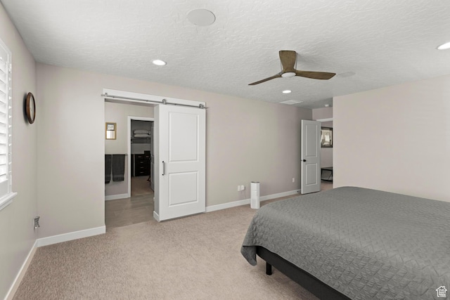 415 W 1410 N Unit 81, Tooele, UT 84074 - bedroom with light carpet, a textured ceiling, baseboards, and a barn door
