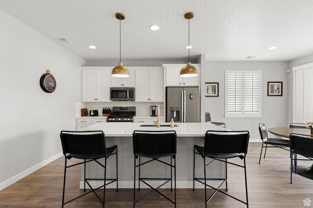 415 W 1410 N Unit 81, Tooele, UT 84074 - kitchen featuring tasteful backsplash, appliances with stainless steel finishes, an island with sink, and light countertops
