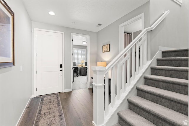 415 W 1410 N Unit 81, Tooele, UT 84074 - foyer entrance featuring visible vents, dark wood-type flooring, baseboards, stairs, and recessed lighting