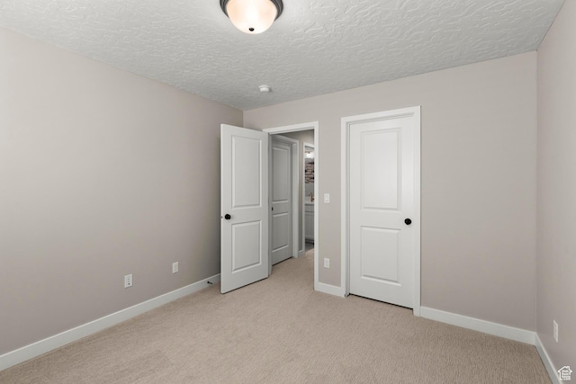 415 W 1410 N Unit 81, Tooele, UT 84074 - unfurnished bedroom with light colored carpet, a textured ceiling, and baseboards