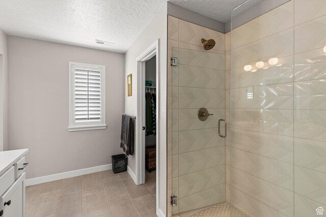 415 W 1410 N Unit 81, Tooele, UT 84074 - full bathroom featuring vanity, baseboards, visible vents, a shower stall, and a textured ceiling