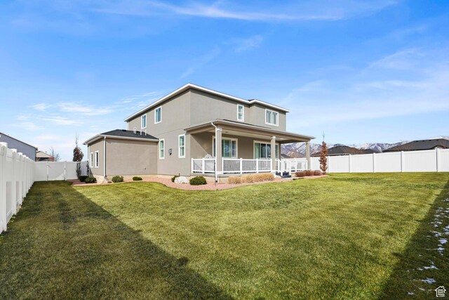 415 W 1410 N Unit 81, Tooele, UT 84074 - rear view of house with a yard, a porch, a fenced backyard, and stucco siding