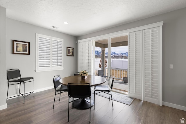 415 W 1410 N Unit 81, Tooele, UT 84074 - dining space with visible vents, a textured ceiling, baseboards, and wood finished floors