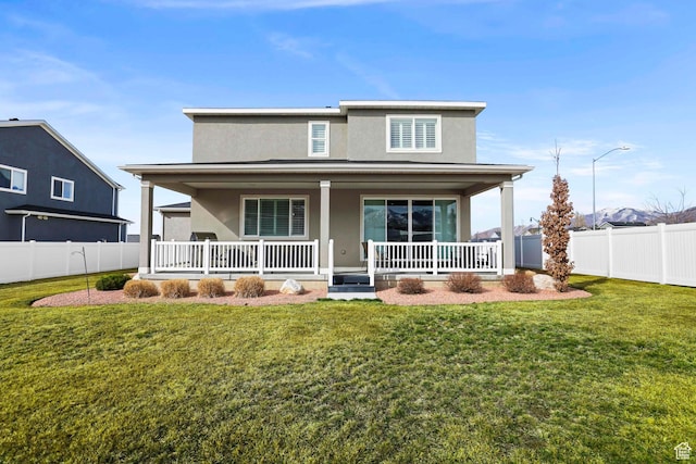415 W 1410 N Unit 81, Tooele, UT 84074 - back of house with a yard, fence, covered porch, and stucco siding