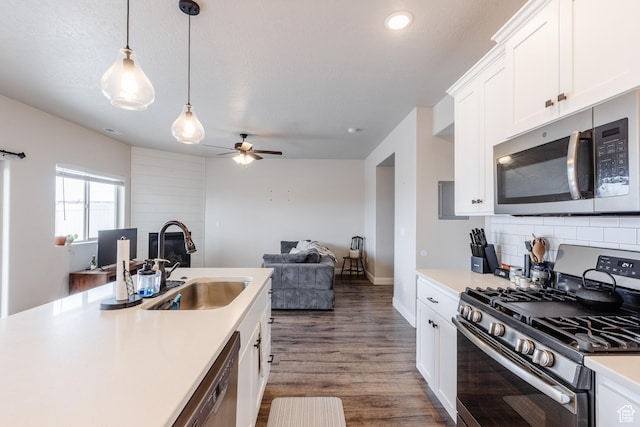 3084 W 1750 N Unit 1, Cedar City, UT 84721 - kitchen featuring backsplash, light countertops, appliances with stainless steel finishes, a ceiling fan, and a sink