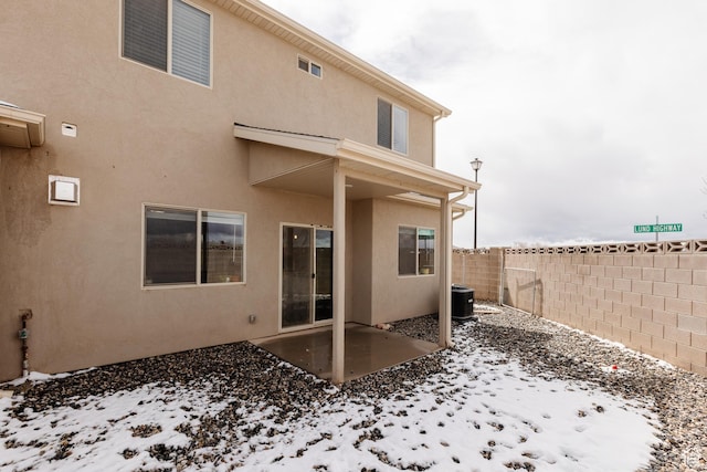 3084 W 1750 N Unit 1, Cedar City, UT 84721 - snow covered house featuring a patio, a fenced backyard, central AC, and stucco siding