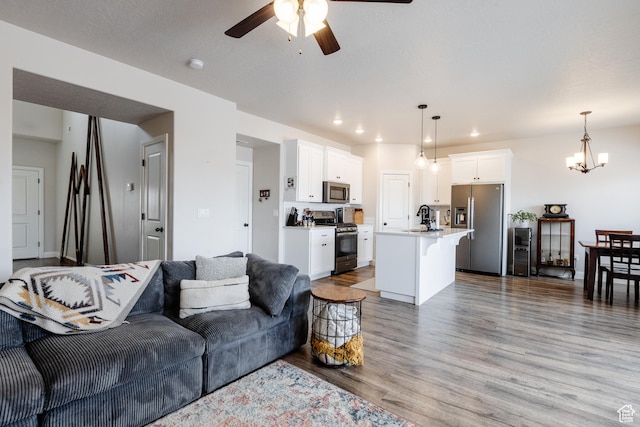 3084 W 1750 N Unit 1, Cedar City, UT 84721 - living area featuring wood finished floors, recessed lighting, and ceiling fan with notable chandelier