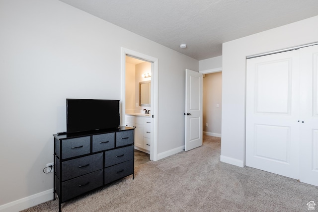 3084 W 1750 N Unit 1, Cedar City, UT 84721 - bedroom with baseboards, light colored carpet, ensuite bath, a closet, and a textured ceiling