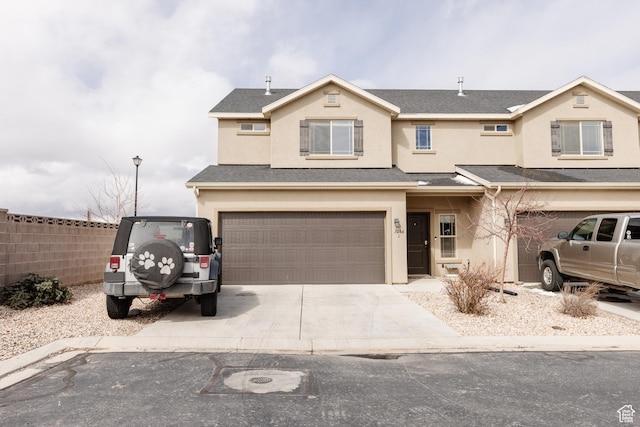 3084 W 1750 N Unit 1, Cedar City, UT 84721 - view of front of home with a shingled roof, fence, stucco siding, a garage, and driveway