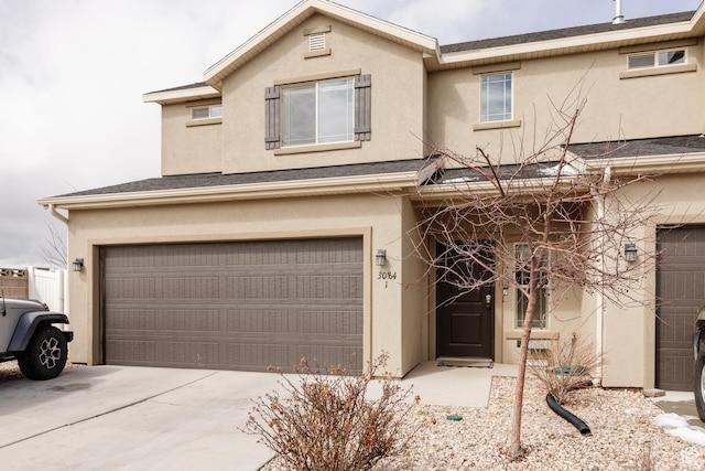3084 W 1750 N Unit 1, Cedar City, UT 84721 - view of front of property with stucco siding, an attached garage, and driveway