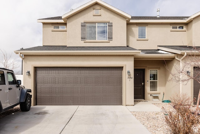 3084 W 1750 N Unit 1, Cedar City, UT 84721 - townhome / multi-family property with stucco siding, concrete driveway, a garage, and roof with shingles
