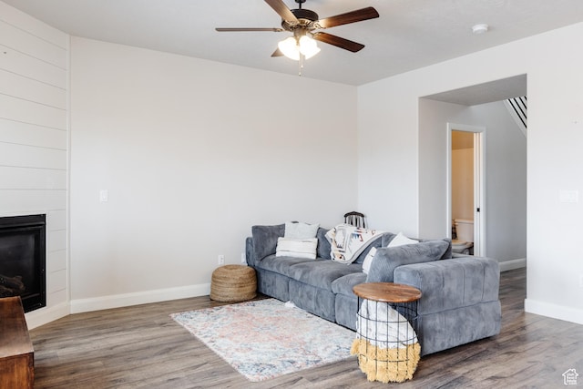 3084 W 1750 N Unit 1, Cedar City, UT 84721 - living room featuring a fireplace, baseboards, a ceiling fan, and wood finished floors