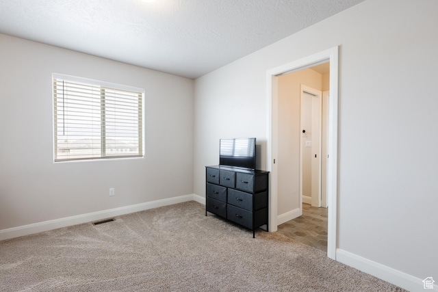 3084 W 1750 N Unit 1, Cedar City, UT 84721 - bedroom with a textured ceiling, baseboards, visible vents, and light carpet