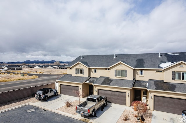 3084 W 1750 N Unit 1, Cedar City, UT 84721 - multi unit property featuring concrete driveway, a mountain view, a garage, and stucco siding