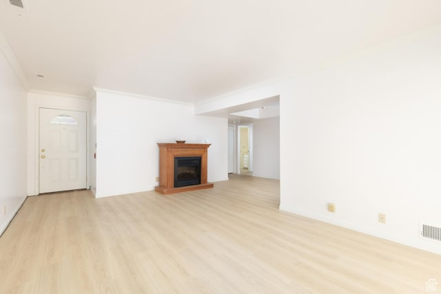 1525 E Waterbury Dr Unit D, Salt Lake City, UT 84121 - unfurnished living room with ornamental molding, light wood finished floors, a fireplace with raised hearth, and baseboards
