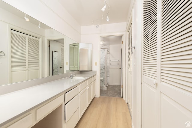 1525 E Waterbury Dr Unit D, Salt Lake City, UT 84121 - full bath featuring a closet, vanity, wood finished floors, and a stall shower