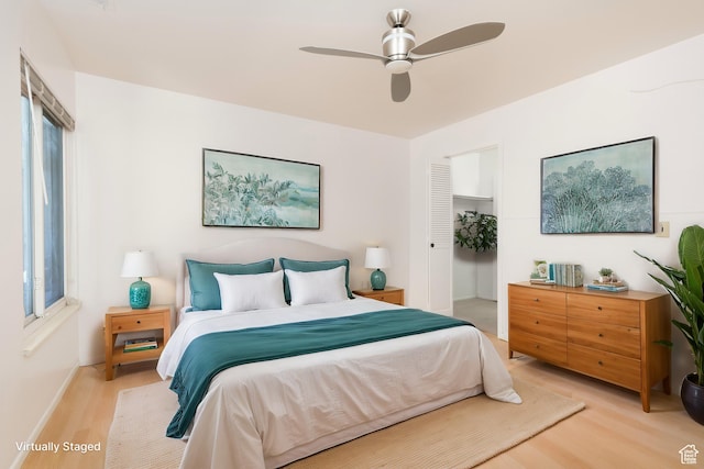 1525 E Waterbury Dr Unit D, Salt Lake City, UT 84121 - bedroom with light wood finished floors, a closet, ceiling fan, and baseboards