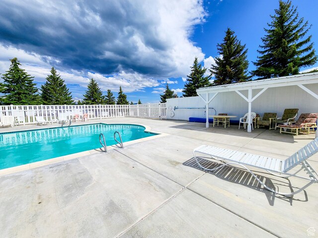 3030 S Edgemont Dr Unit 159, Garden City, UT 84028 - view of swimming pool with a patio area, a fenced in pool, and fence