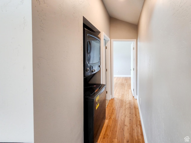 3030 S Edgemont Dr Unit 159, Garden City, UT 84028 - hallway featuring stacked washer and clothes dryer, baseboards, light wood-style floors, and a textured wall