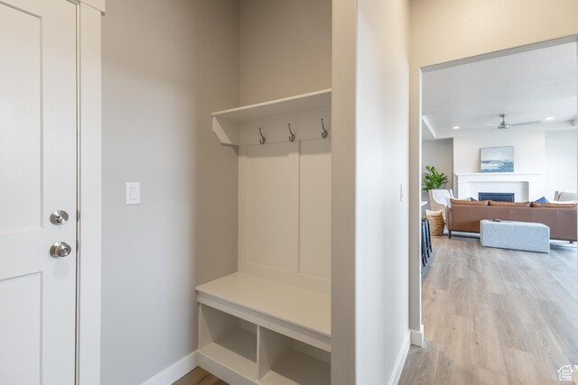 3077 N 2875 W Unit 5, Plain City, UT 84404 - mudroom with a fireplace, ceiling fan, light wood-style flooring, and baseboards